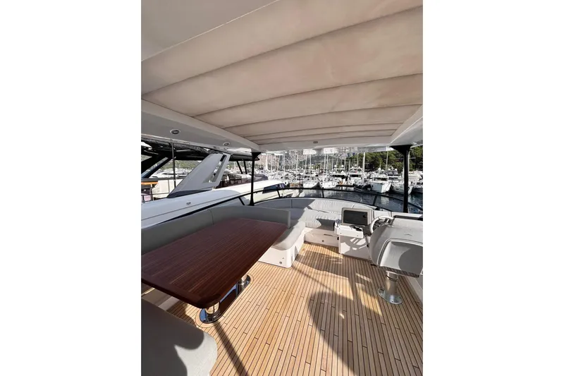  Yacht Photos Pics Luxurious 2025 Benetti Azimut MAGELLANO 66 yacht deck with seating and marina view.
