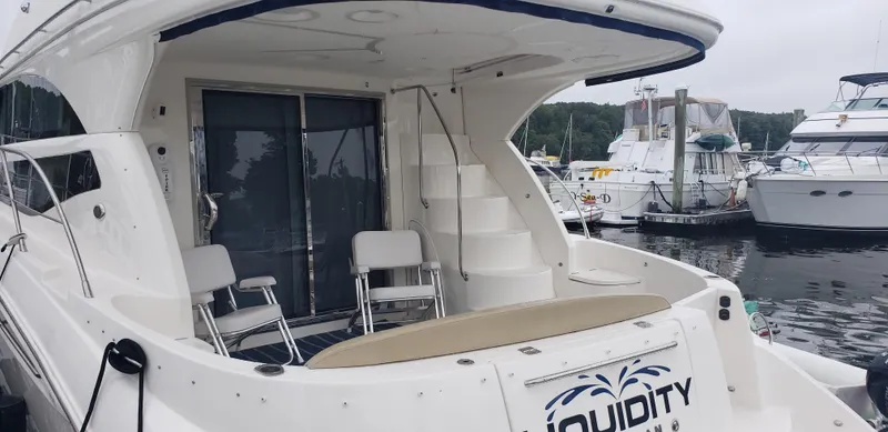  Yacht Photos Pics 2010 Meridian 441 Sedan yacht docked at marina, featuring spacious deck and seating area.