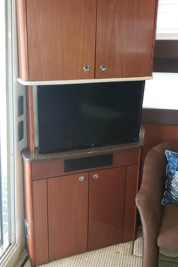  Yacht Photos Pics 2010 Meridian 441 Sedan interior with TV and wooden cabinetry.