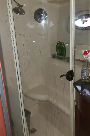  Yacht Photos Pics Shower area in 2010 Meridian 441 Sedan yacht with glass door and porthole.