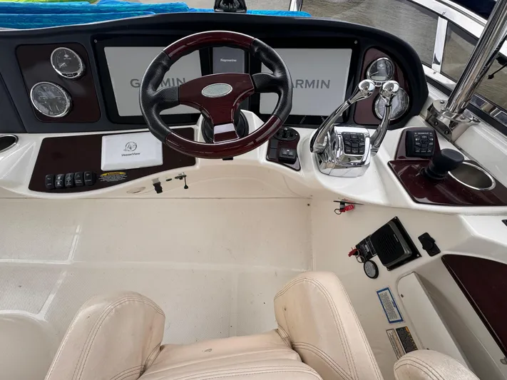  Yacht Photos Pics 2010 Meridian 441 Sedan helm with Garmin navigation, steering wheel, and control panel.