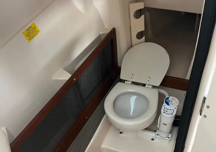  Yacht Photos Pics 2022 Grady-White Freedom 275 boat interior with compact marine toilet.