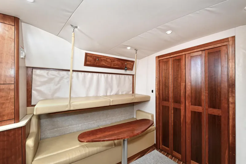 Two & Five Yacht Photos Pics Interior of 2013 Albemarle 360 Express Fisherman with wood accents and beige seating.