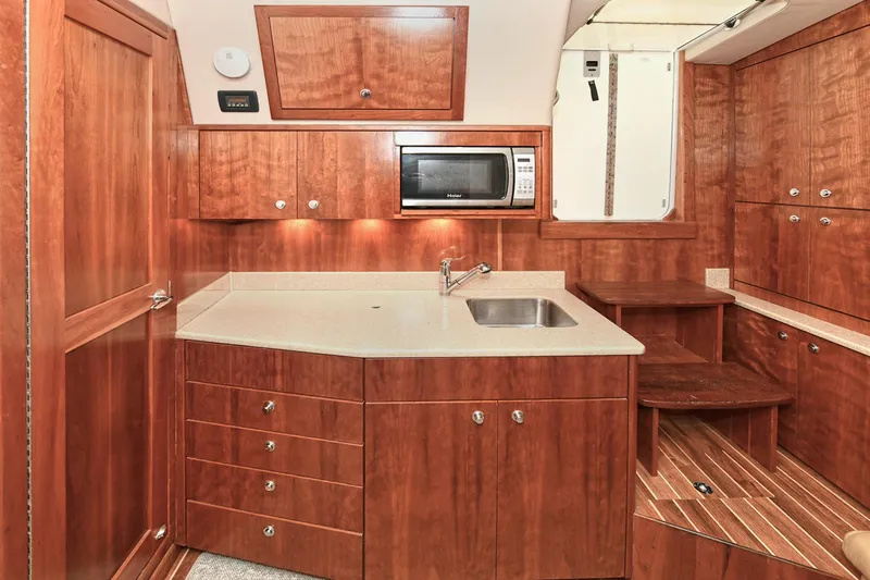Two & Five Yacht Photos Pics Luxurious 2013 Albemarle 360 Express Fisherman yacht kitchen with wood cabinetry and modern amenities.