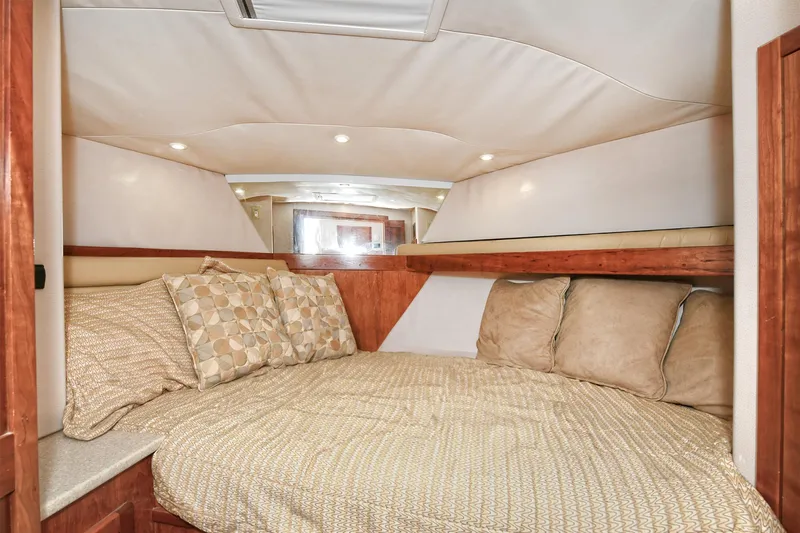 Two & Five Yacht Photos Pics 2013 Albemarle 360 Express Fisherman cabin with cozy bedding and wooden accents.