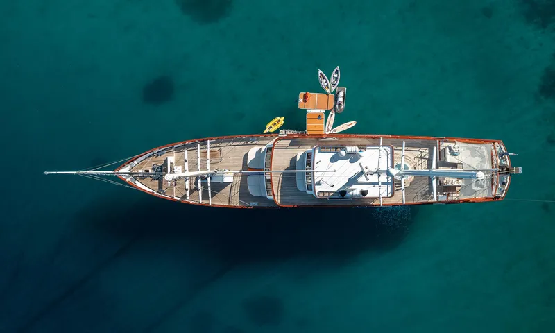 Corsario Yacht Photos Pics Aerial view of 2019 Custom RADEŽ d.d. Schooner anchored in clear blue water.