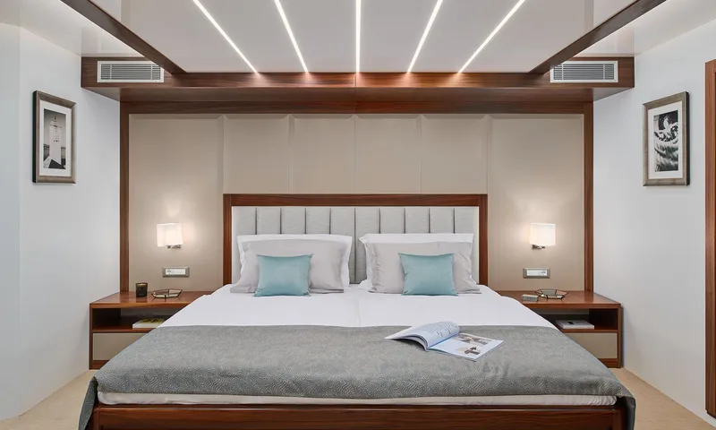 Corsario Yacht Photos Pics Luxurious bedroom on the 2019 Custom RADEŽ d.d. Schooner with modern decor and ambient lighting.