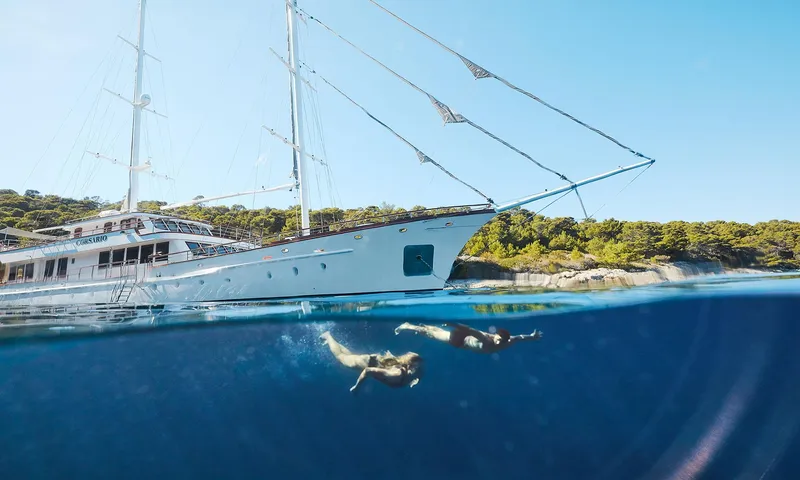Corsario Yacht Photos Pics Custom RADEŽ d.d. Schooner 2019 with swimmers in clear blue water.