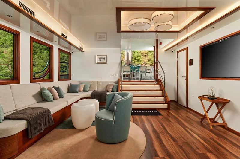 Corsario Yacht Photos Pics Luxurious interior of 2019 Custom RADEŽ d.d. Schooner with modern furnishings and wooden flooring.