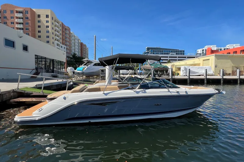Helena Yacht Photos Pics 2020 Sea Ray 280 SLX boat docked in a marina with urban buildings in the background.