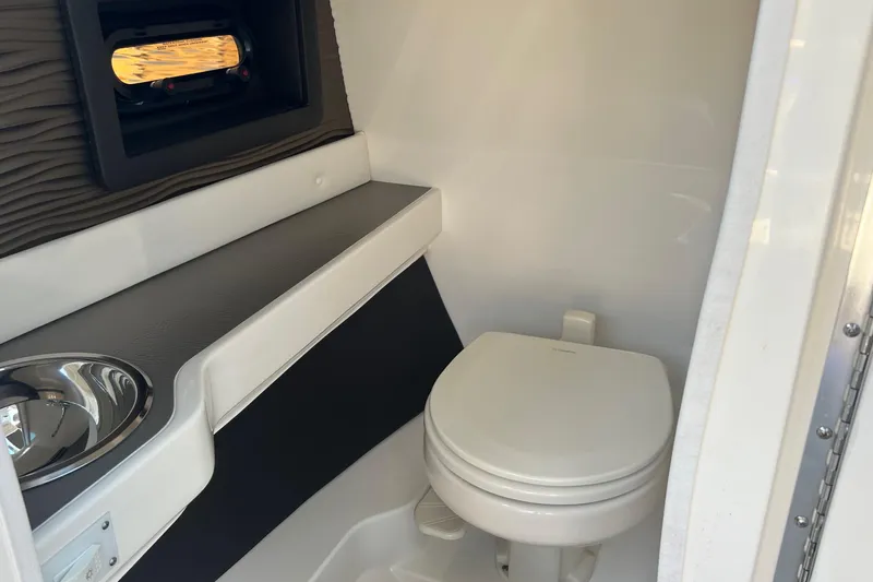 Helena Yacht Photos Pics 2020 Sea Ray 280 SLX boat interior with compact bathroom and window.