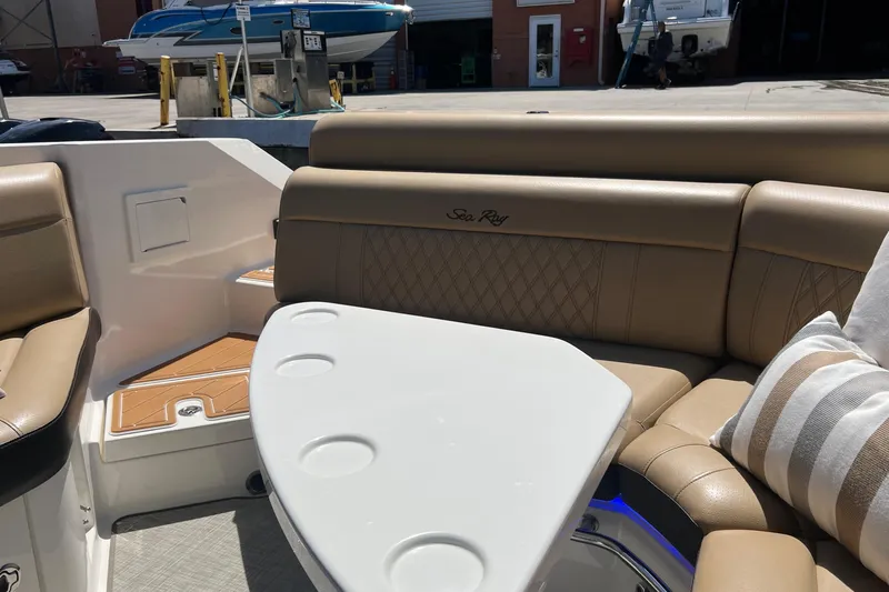 Helena Yacht Photos Pics 2020 Sea Ray 280 SLX boat interior with tan leather seating and white table.