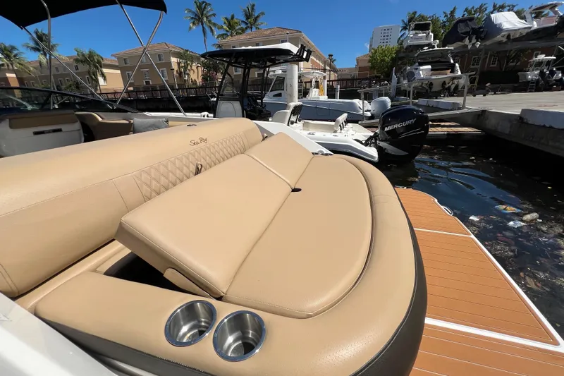 Helena Yacht Photos Pics 2020 Sea Ray 280 SLX boat with tan seating, docked near palm trees and buildings.