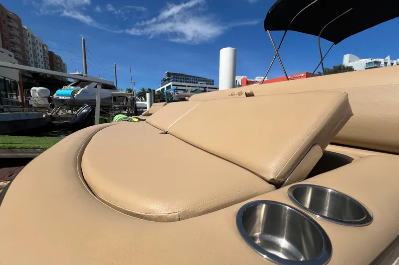 Helena Yacht Photos Pics 2020 Sea Ray 280 SLX boat with tan leather seating and cup holders, docked under blue sky.