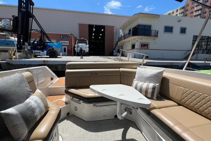 Helena Yacht Photos Pics 2020 Sea Ray 280 SLX boat interior with beige seating and table at a marina.