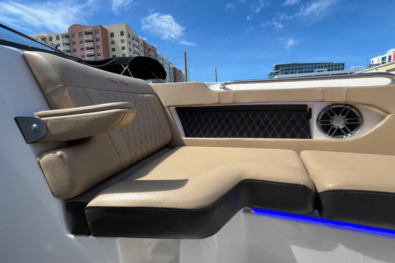Helena Yacht Photos Pics Luxurious seating on a 2020 Sea Ray 280 SLX boat, with urban skyline backdrop.