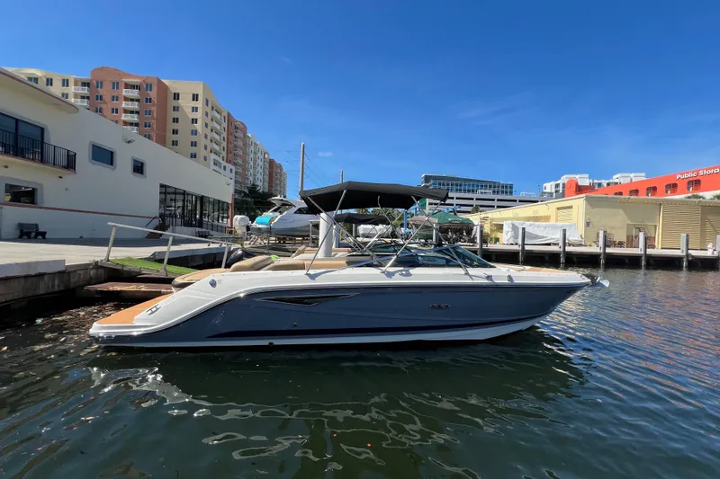 Helena Yacht Photos Pics 2020 Sea Ray 280 SLX boat docked in urban marina under clear blue sky.