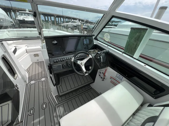 Blackfin Yacht Photos Pics 2023 Blackfin 272DC boat interior with modern dashboard and steering wheel.