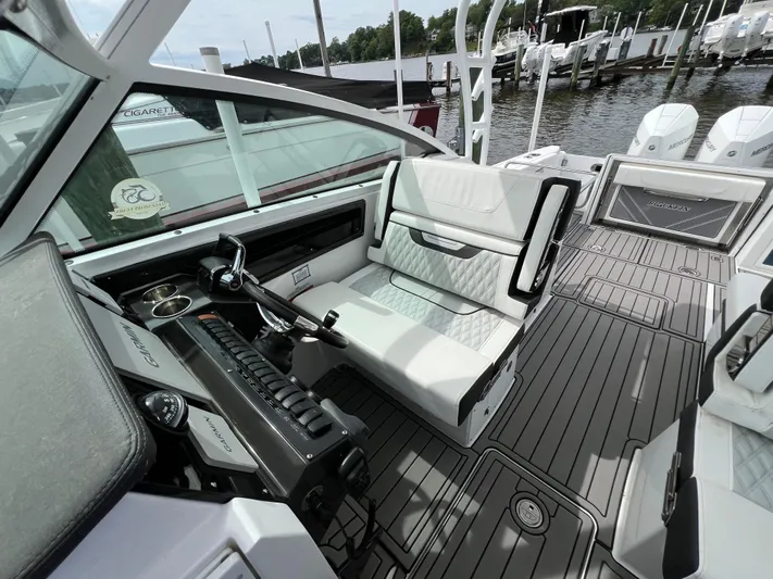 Blackfin Yacht Photos Pics 2023 Blackfin 272DC boat interior with modern seating and control panel.