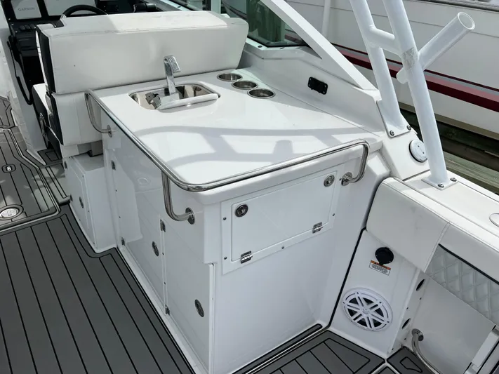 Blackfin Yacht Photos Pics 2023 Blackfin 272DC boat interior with sink and storage area.