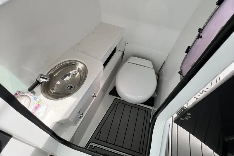 Blackfin Yacht Photos Pics 2023 Blackfin 272DC boat bathroom with sink and toilet, featuring modern design.