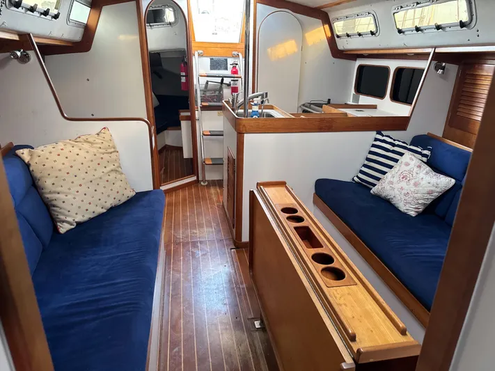 Valcor II Yacht Photos Pics Interior of 1996 J Boats J/42 sailboat with cozy seating and wooden accents.
