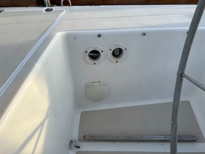 Valcor II Yacht Photos Pics Cockpit area of 1996 J Boats J/42 sailboat, showing deck fittings and storage compartment.