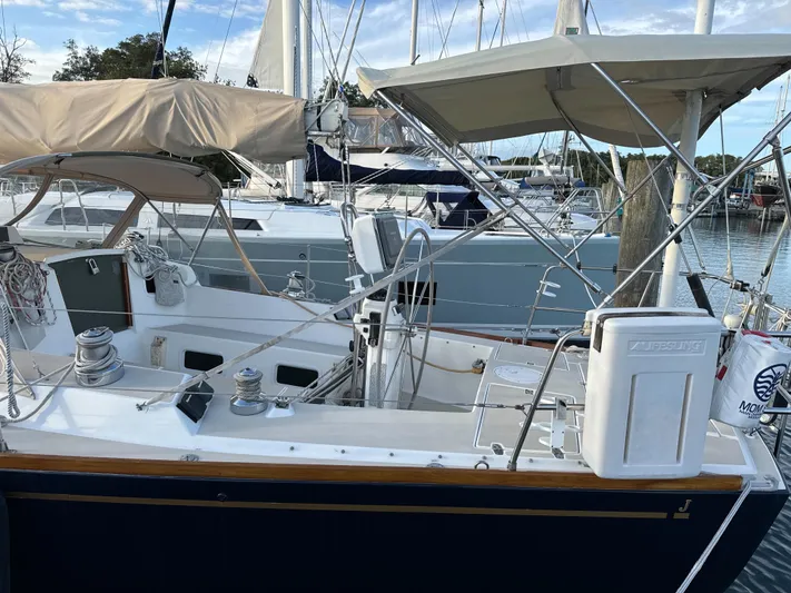 Valcor II Yacht Photos Pics 1996 J Boats J/42 sailboat docked, featuring a spacious cockpit and covered helm.