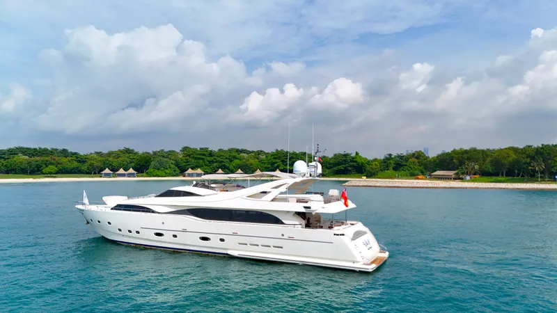 Eaglewings 3 Yacht Photos Pics Luxurious 2005 Custom Line 112 yacht cruising near a lush, green coastline.