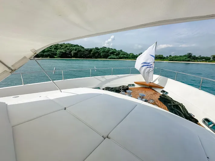 Eaglewings 3 Yacht Photos Pics Luxury yacht deck with white seating, Custom Line 112, 2005, overlooking serene water and lush greenery.