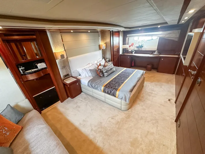 Eaglewings 3 Yacht Photos Pics Luxurious bedroom interior on a 2005 Custom Line 112 yacht, featuring elegant decor and ample natural light.