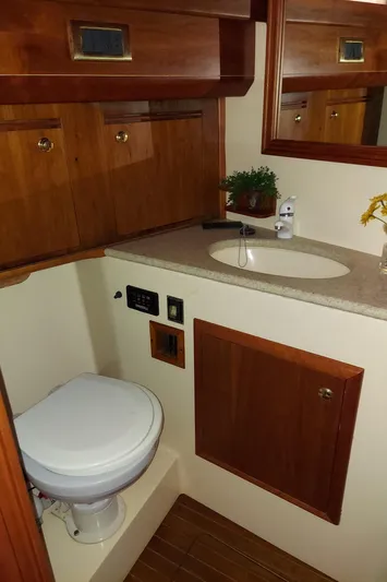 No Name Yacht Photos Pics 2001 Apreamare 10M Cabinato bathroom with wooden cabinets and modern fixtures.