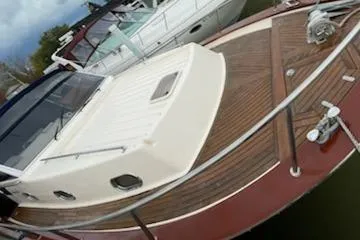 No Name Yacht Photos Pics 2001 Apreamare 10M Cabinato boat with wooden deck and white cabin, docked at marina.