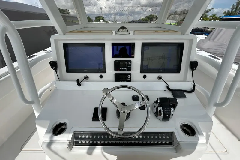 Trailer Included Yacht Photos Pics Cockpit of 2019 Invincible 40 Catamaran with dual screens and steering wheel.