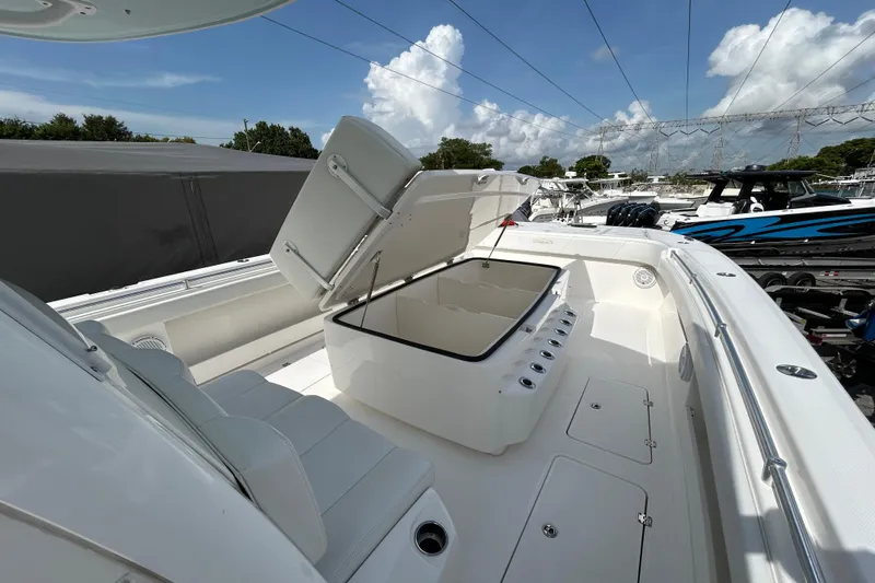 Trailer Included Yacht Photos Pics 2019 Invincible 40 Catamaran with open storage compartment, sleek design, and spacious deck.