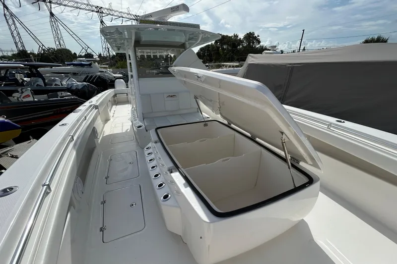Trailer Included Yacht Photos Pics 2019 Invincible 40 Catamaran with open storage compartment, docked at marina.