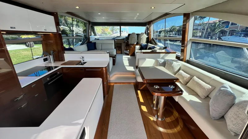  Yacht Photos Pics Luxurious interior of a 2019 Princess F62 yacht with modern furnishings and large windows.