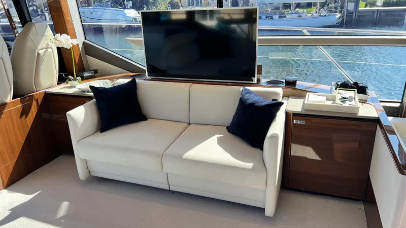  Yacht Photos Pics Luxurious 2019 Princess F62 yacht interior with sofa, TV, and waterfront view.