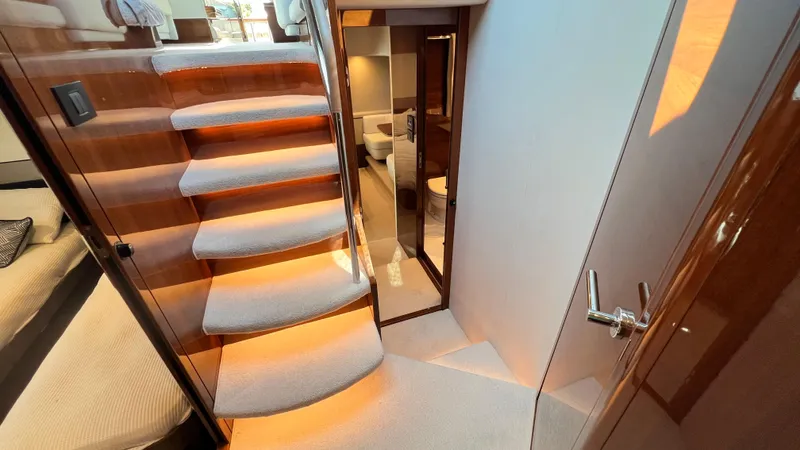  Yacht Photos Pics Luxurious interior of 2019 Princess F62 yacht with elegant staircase and modern design.