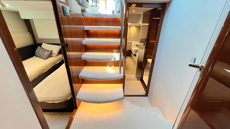  Yacht Photos Pics Luxurious interior of 2019 Princess F62 yacht with elegant staircase and cozy cabin.