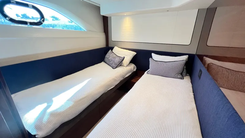  Yacht Photos Pics Luxurious twin cabin interior of 2019 Princess F62 yacht with elegant bedding.