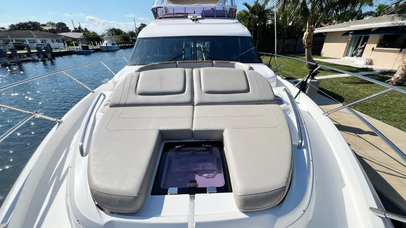  Yacht Photos Pics Luxurious 2019 Princess F62 yacht with sunbathing deck, docked in a scenic marina.