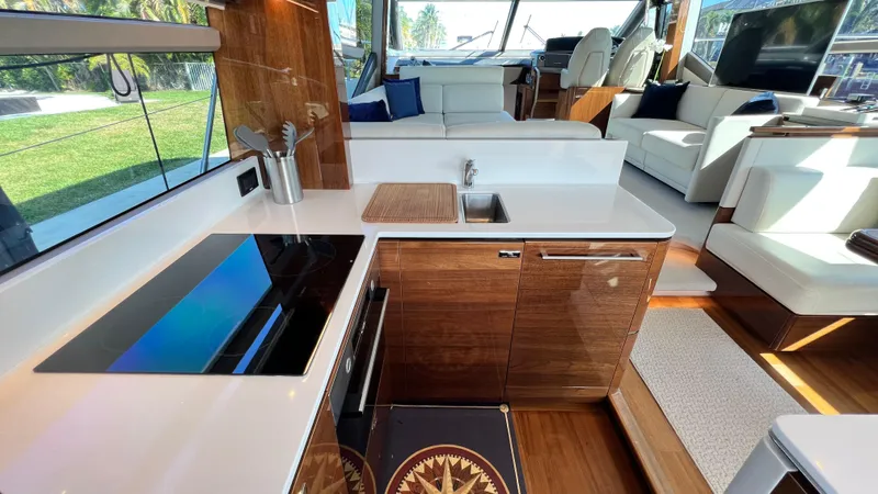  Yacht Photos Pics Luxurious interior of 2019 Princess F62 yacht with modern kitchen and seating area.