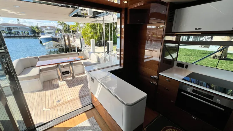  Yacht Photos Pics Luxurious 2019 Princess F62 yacht interior with modern kitchen and outdoor seating area.