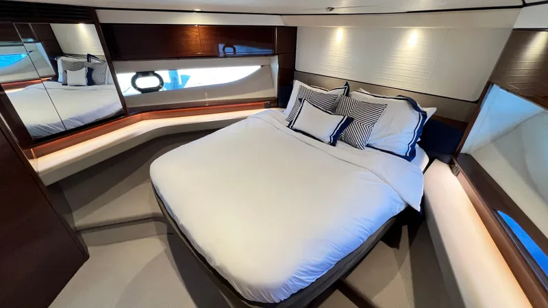  Yacht Photos Pics Luxurious cabin interior of 2019 Princess F62 yacht with elegant bedding and modern design.