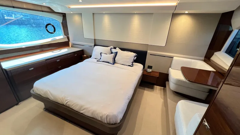  Yacht Photos Pics Luxurious bedroom interior of 2019 Princess F62 yacht with elegant furnishings and large window view.