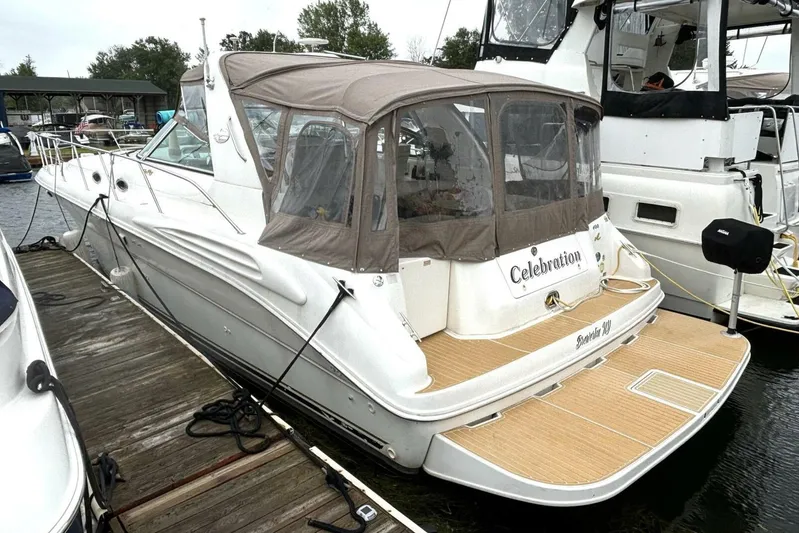  Yacht Photos Pics 1998 Sea Ray 400 Sundancer docked, featuring a covered cockpit and sleek design.
