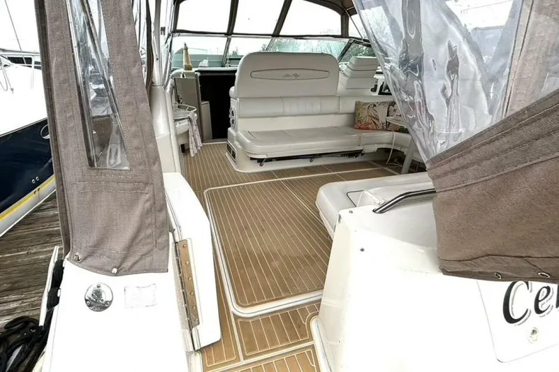  Yacht Photos Pics 1998 Sea Ray 400 Sundancer interior with beige seating and wood-style flooring.