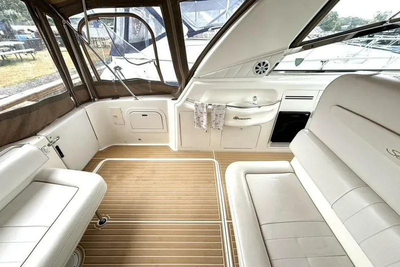  Yacht Photos Pics 1998 Sea Ray 400 Sundancer interior with white seating and wood flooring.