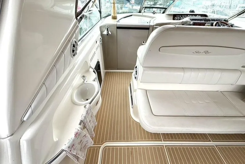  Yacht Photos Pics 1998 Sea Ray 400 Sundancer interior with white seating and wooden flooring.